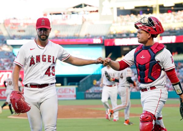 Starting pitcher Patrick Sandoval (43) of the Los Angeles Angels fist bumps catcher Matt Thaiss (21) after pitching out of a jam in the second inning against San Francisco Giants at Angel Stadium of Anaheim in Anaheim, Calif.,on August 7, 2023. (Kevork Djansezian/Getty Images)