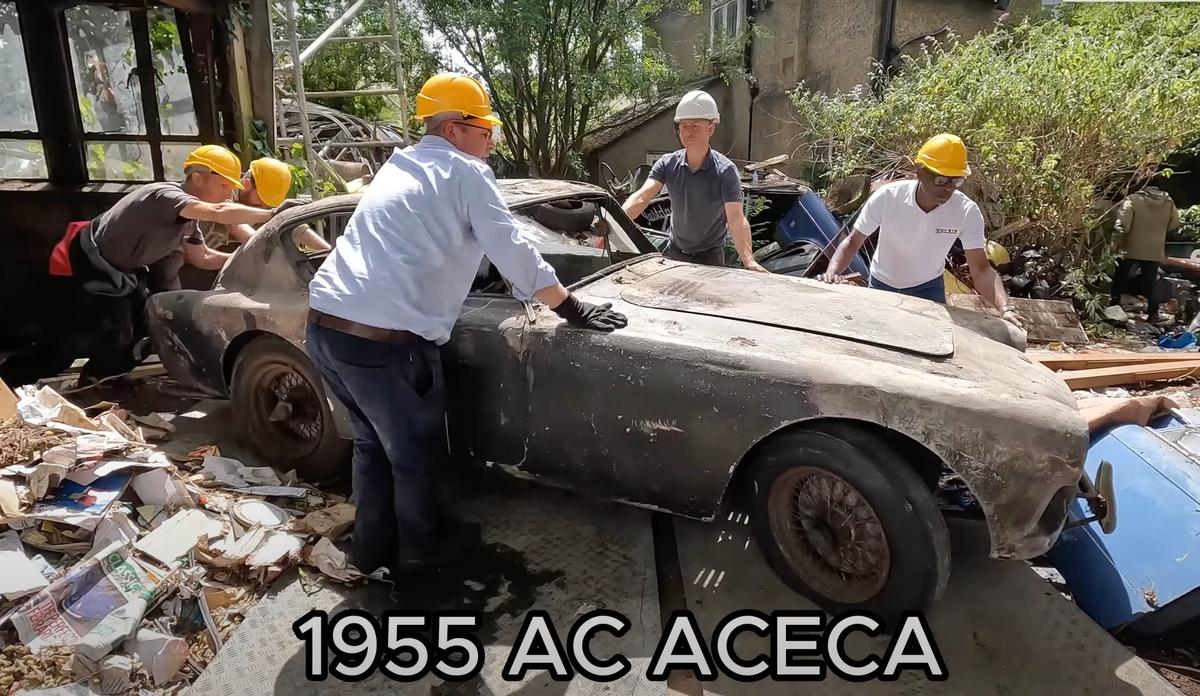 The team from Anglia Car Auctions extract a 1955 AC ACECA from the barn. (Courtesy of Anglia Car Auctions)