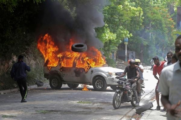 A vehicle set on fire by protesters burns during a demonstration against insecurity in Port-au-Prince, Haiti, on Aug. 7, 2023. (Odelyn Joseph/AP Photo)