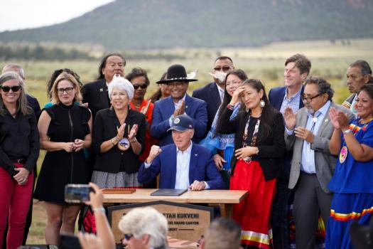 President Joe Biden (C) signs a proclamation making the Baaj Nwaavjo I'tah Kukveni Ancestral Footprints part of the Grand Canyon National Monument after he spoke about his administration’s investments in conservation and clean energy at Red Butte Airfield, Ariz., on Aug. 8, 2023. (Madalina Vasiliu/The Epoch Times)