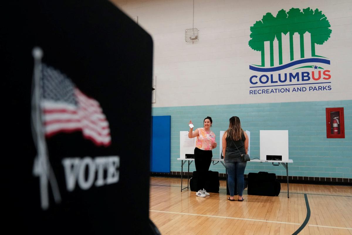 Volunteer Amelia Klein helps voters cast their ballots during a special election for Issue 1 at the Schiller Recreation Center in German Village in Columbus, Ohio, on Aug. 8, 2023. (Adam Cairns/USA Today Network via Reuters)