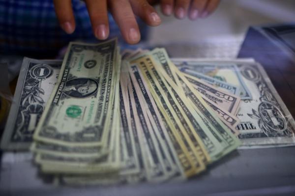 Dollar Edges Lower Ahead of Fed's Powell Comments