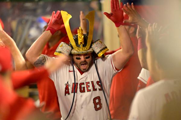 Mike Moustakas (8) of the Los Angeles Angels is greeted in the dugout after hitting a three run home run in the sixth inning against the San Francisco Giants at Angel Stadium of Anaheim in Anaheim, Calif., on August 9, 2023. (ayne Kamin-Oncea/Getty Images)