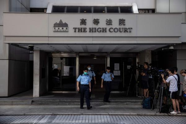 Police personnel patrol at the High Court in Hong Kong on July 28, 2023. (Isaac Lawrence/AFP via Getty Images)