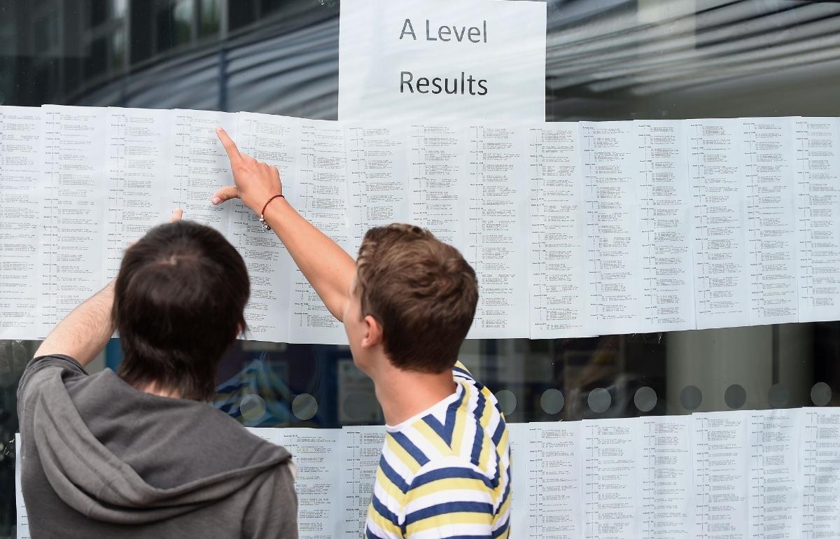 Students check their A-level results at Worcester Sixth Form College on Aug. 14, 2014. One in five students awaiting A-level results plans to live at home while studying at university, prompting concerns that cost pressures are limiting young people's educational choices. (PA Media)