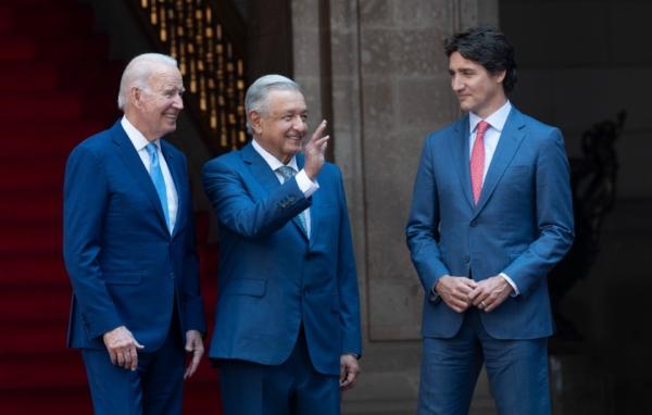 Mexican President Andres Manuel Lopez Obrador waves as he poses with U.S. President Joe Biden and Prime Minister Justin Trudeau at the North American Leaders Summit on Jan. 10, 2023, in Mexico City. (Adrian Wyld/The Canadian Press)
