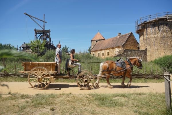 Horse-drawn cart hauling timbers for castle construction. (Courtesy of Guédelon)