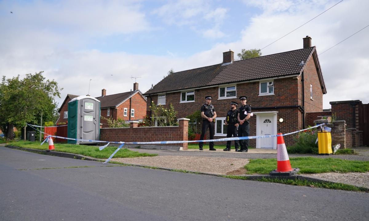 Surrey Police officers outside a property on Hammond Road in Woking, Surrey, on Aug. 11, 2023, one day after a 10-year-old girl was found dead in the property. (Jonathan Brady/PA)