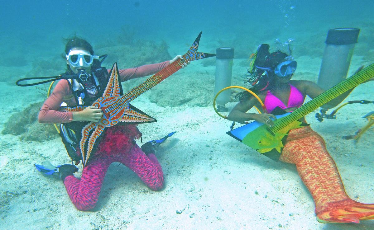 Mermaids and mermen “play” instruments at the Underwater Music Festival in the Florida Keys. (Courtesy of Mike Papish)