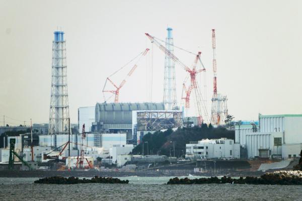 The Fukushima Daiichi nuclear power plant sits in coastal towns of both Okuma and Futaba, as seen from the Ukedo fishing port in Namie town, northeastern Japan, on March 2, 2022. (AP Photo/Hiro Komae)