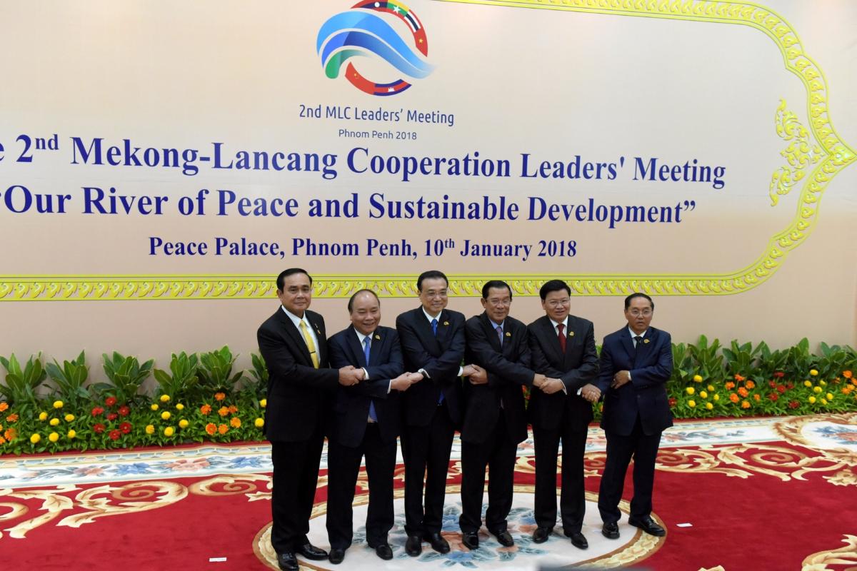 (L to R) Thai Prime Minster Prayuth Chan-O-Cha, Vietnamese Prime Minister Nguyen Xuan Phuc, Chinese Prime Minster Li Keqiang, Cambodian Prime Minster Hun Sen, Laos' Prime Minster Thongloun Sisoulith, and Myanmar Vice President Mint Swe link arms during the second Mekong-Lancang Cooperation leaders' meeting at the Peace Palace in Phnom Penh, Cambodia, on Jan. 10, 2018. (Tang Chhin Sothy / AFP via Getty Images)