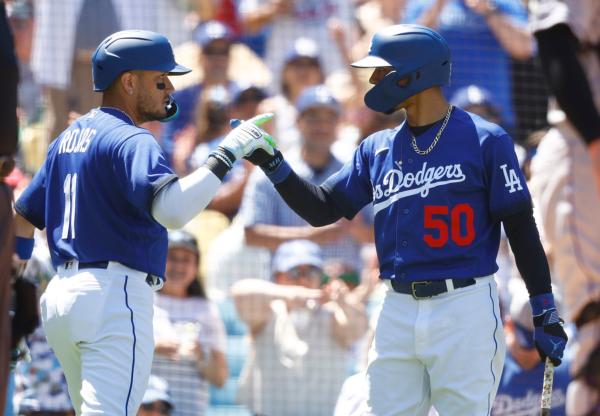 Miguel Rojas (11) of the Los Angeles Dodgers celebrates a home run with Mookie Betts (50) against the Colorado Rockies in the fourth inning at Dodger Stadium in Los Angeles on August 13, 2023. (Ronald Martinez/Getty Images)