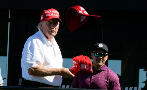 Former President Donald Trump throws signed hats into the crowd at Trump National Golf Club in Bedminster, N.J., on Aug. 13, 2023. (Timothy A. Clary/AFP via Getty Images)