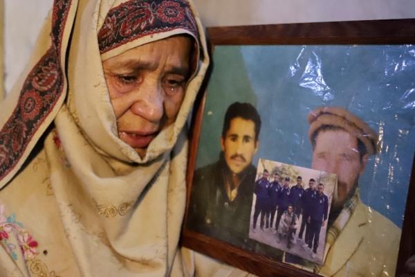 Mother of Mohammed Hassan, a Pakistani porter who died on July 27 during the summiting K2, the world's second-highest peak, weeps while she shows a picture of her son with her husband, during an interview with the Associated Press, in Tasar, a village of Shigar district in Gilgit-Baltistan region in the northern Pakistan, on Aug. 12, 2023. (M.H. Balti/AP Photo)