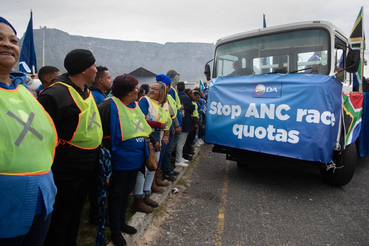 A truck bearing a banner leads supporters of the Democratic Alliance, South Africa's main opposition party, as they march through the city streets to protest against the ruling African National Congress's new proposal for employment quotas along racial lines, in Cape Town on July 26, 2023. (Rodger Bosch/AFP via Getty Images)