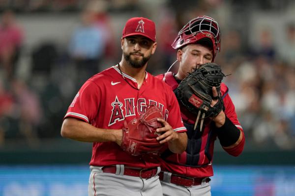 Los Angeles Angels starting pitcher Patrick Sandoval, left, walks off the field while talking to catcher Matt Thaiss, right, as the two worked against the Texas Rangers in the first inning of a baseball game in Arlington, Texas, on Aug. 14, 2023. (Tony Gutierrez/AP Photo)