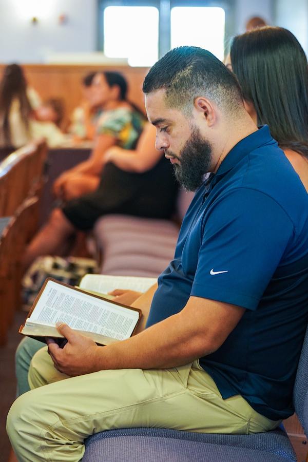 A man reads a Bible passage during a service commemorating the victims of Maui's wildfires in Kihei, Maui, on Aug. 13, 2023. (Allan Stein/The Epoch Times)