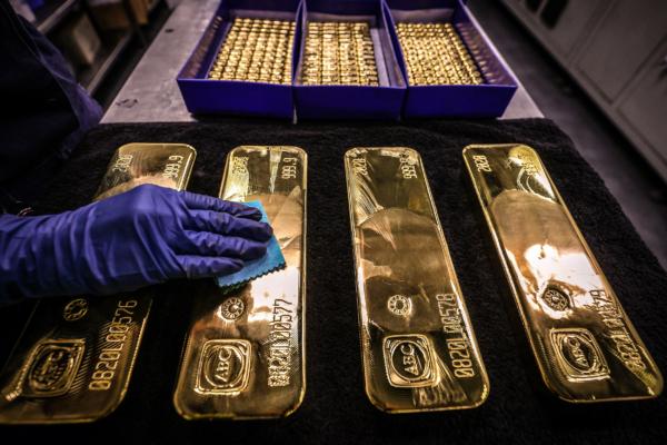A worker polishes gold bullion bars at the ABC Refinery in Sydney on Aug. 5, 2020. (David Gray/AFP via Getty Images)
