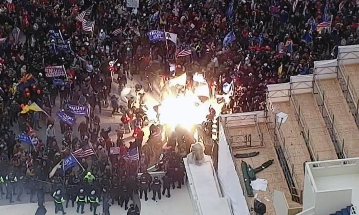 A munition that exploded in the crowd on the west front of the U.S. Capitol in Washington ricocheted off the ground into the leg of a nearby protester on Jan. 6, 2021. (U.S. Capitol Police/Screenshot via The Epoch Times)
