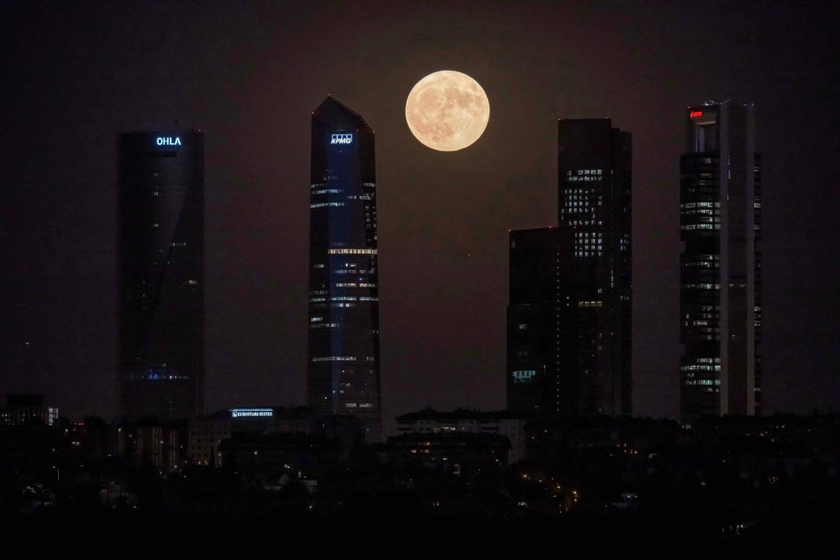 The first of two supermoons in August 2023, a “Sturgeon Moon,” is seen over the Cuatro Torres business area in Madrid, Spain. (JAVIER SORIANO/AFP via Getty Images)