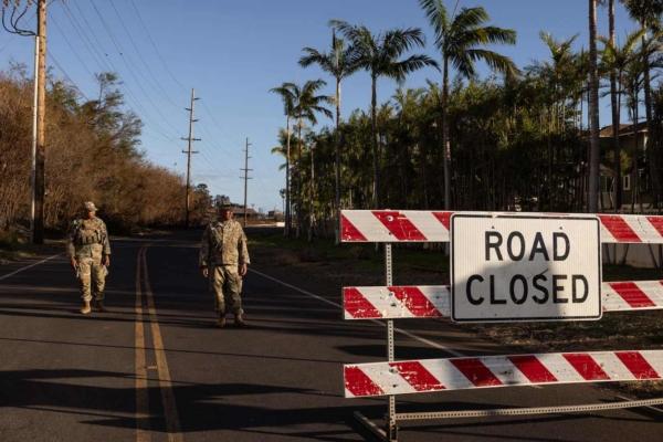 Members of the U.S. National Guard stand on a closed road in Lahaina, western Maui, Hawaii, on Aug. 12, 2023. (Yuki Iwamura/AFP via Getty Images)