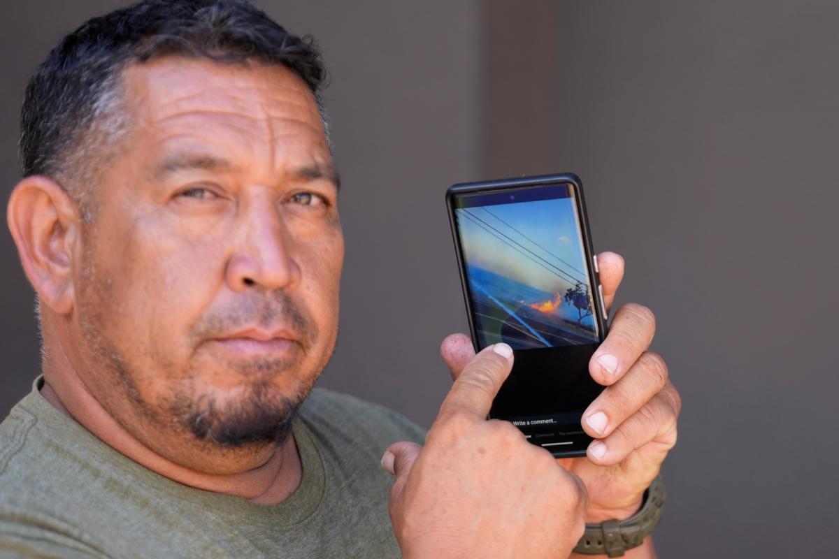 Shane Treu points to his phone while showing the video of the fire during an interview in Wailuku, Hawaii, on Aug. 15, 2023. (Rick Bowmer/AP Photo)