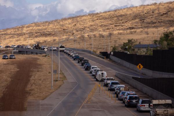 Cars wait in line on Lahaina Bypass road to go to Lahaina in the aftermath of the Maui wildfires in Lahaina, Hawaii, on August 16, 2023. (Photo by Yuki Iwamura/AFP via Getty Images)