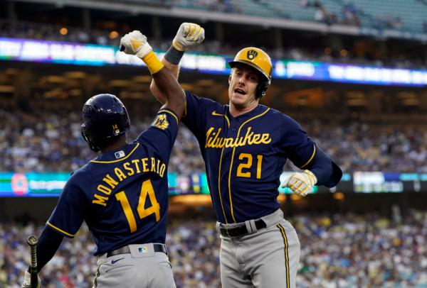 Mark Canha (21) of the Milwaukee Brewers celebrates his solo home run with Andruw Monasterio (14) against the Los Angeles Dodgers in the second inning at Dodger Stadium in Los Angeles on August 16, 2023. (Kevork Djansezian/Getty Images)