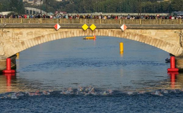 Athletes swim in the Seine river on the first leg of the women's triathlon test event for the Paris 2024 Olympics Games in Paris on Aug. 17, 2023. (Michel Euler/AP Photo)
