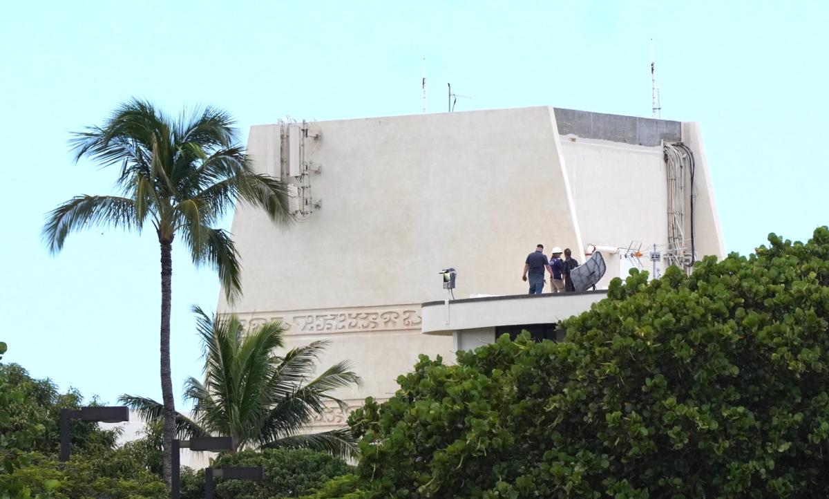 Lahaina residents watch relief efforts from the rooftop of an evacuated building on Aug. 12, 2023. (Allan Stein/The Epoch Times)
