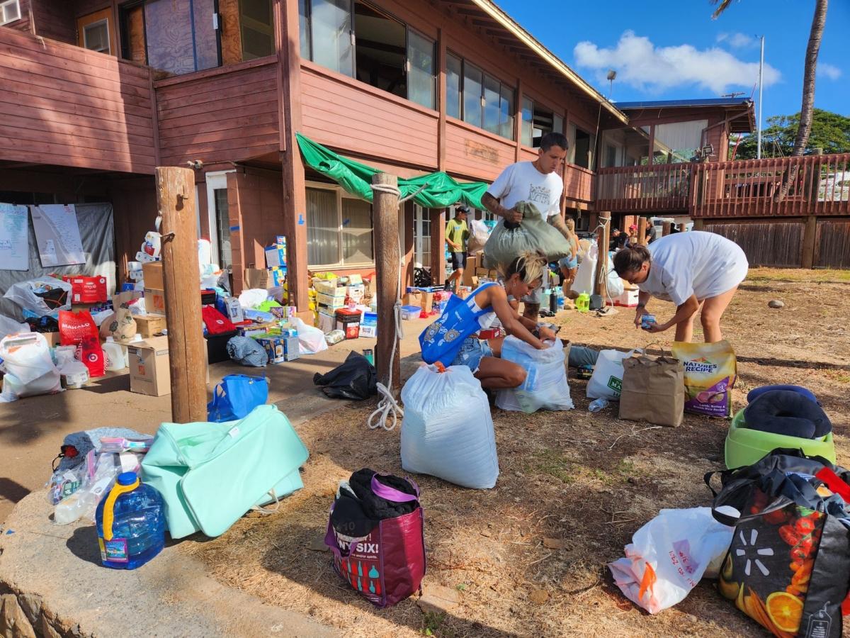 Volunteers work with donated supplies at Buzz's Wharf in Lahaina, Maui, on Aug. 12, 2023. (Allan Stein/The Epoch Times)