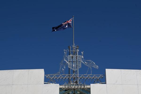 The Australian flag is seen at full mast after the Proclamation of King Charles III, on the forecourt of Parliament House on Sept. 11, 2022 in Canberra, Australia. (Mick Tsikas - Pool/Getty Images)