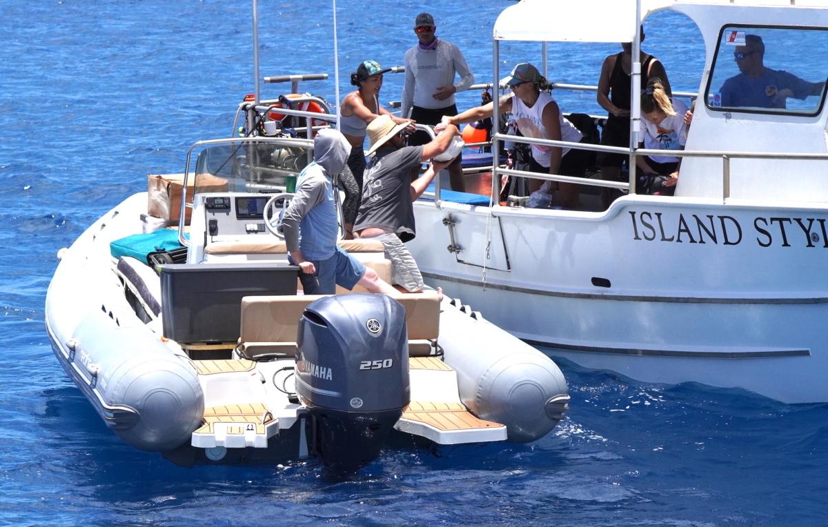 A zodiac delivers a cargo of donated supplies off the shores of Lahaina, West Maui, on Aug. 12, 2023. (Allan Stein/The Epoch Times)