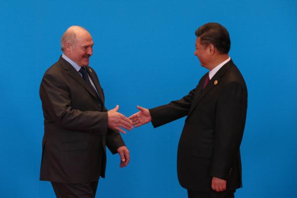 Chinese leader Xi Jinping (R) shakes hands with Belarus President Alexander Lukashenko as they attend the welcome ceremony at Yanqi Lake during the Belt and Road Forum in Beijing on May 15, 2017. (Roman Pilpey-Pool/Getty Images)