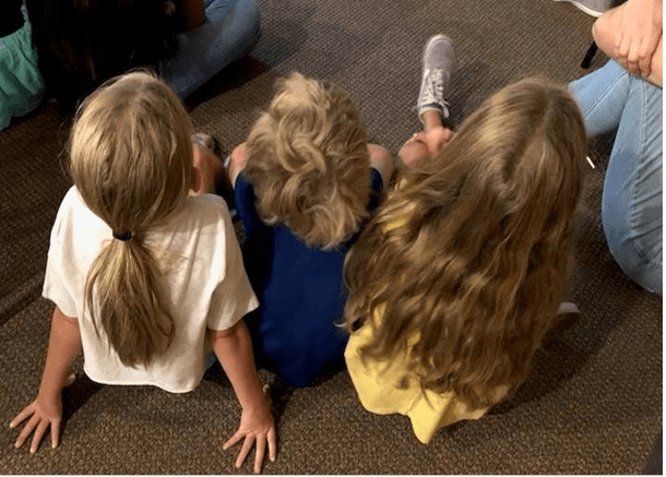 Three little girls listen during the Rincon Valley Library story hour in Santa Rosa, Calif., on Aug. 5, 2023. (Courtesy of Cindy Pedrazzini)