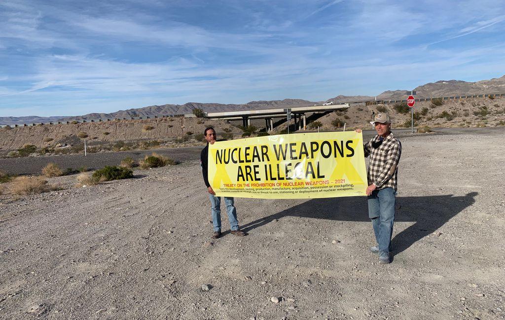 Native American activists Ian Zabarte (L), and Kevin Kamps hold a banner protesting nuclear weapons near the Nevada National Security Site, where 928 nuclear weapons were tested, in "Downwind." (Backlot Docs)