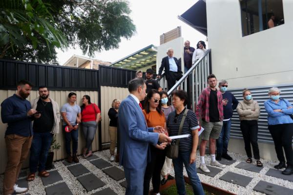 Prospective buyers attend an auction of a residential property in Sydney, Australia, on May 8, 2021. (Lisa Maree Williams/Getty Images)