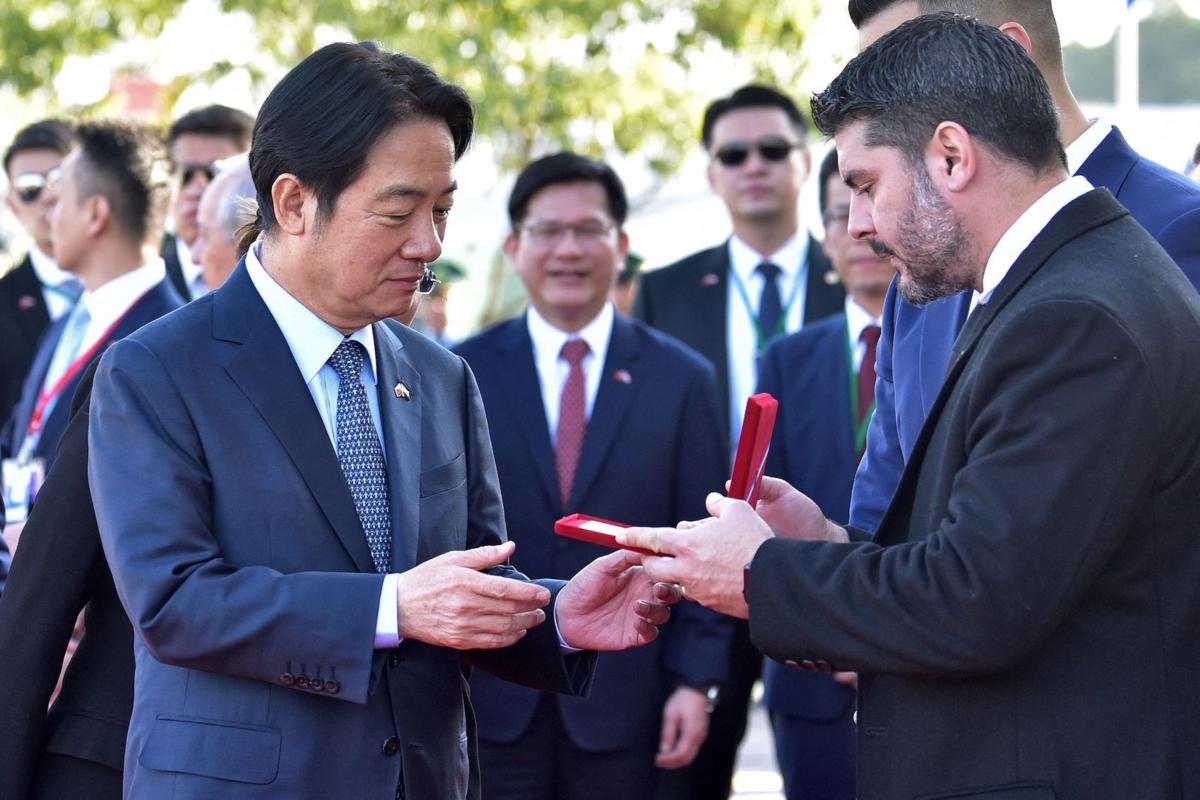 Taiwan's Vice President William Lai Ching-te (left) receives the Key to the City from Asuncion's Mayor Oscar Rodriguez upon landing at Silvio Pettirossi International Airport in Luque, Paraguay, on Aug. 14, 2023, where he arrived to attend the inauguration of President-elect Santiago Pena. (Norberto Duarte/AFP via Getty Images)