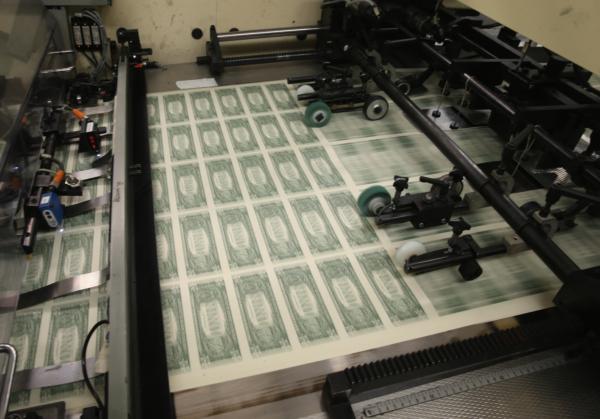 Sheets of $1 bills run through the printing press at the Bureau of Engraving and Printing in Washington on March 24, 2015. (Mark Wilson/Getty Images)