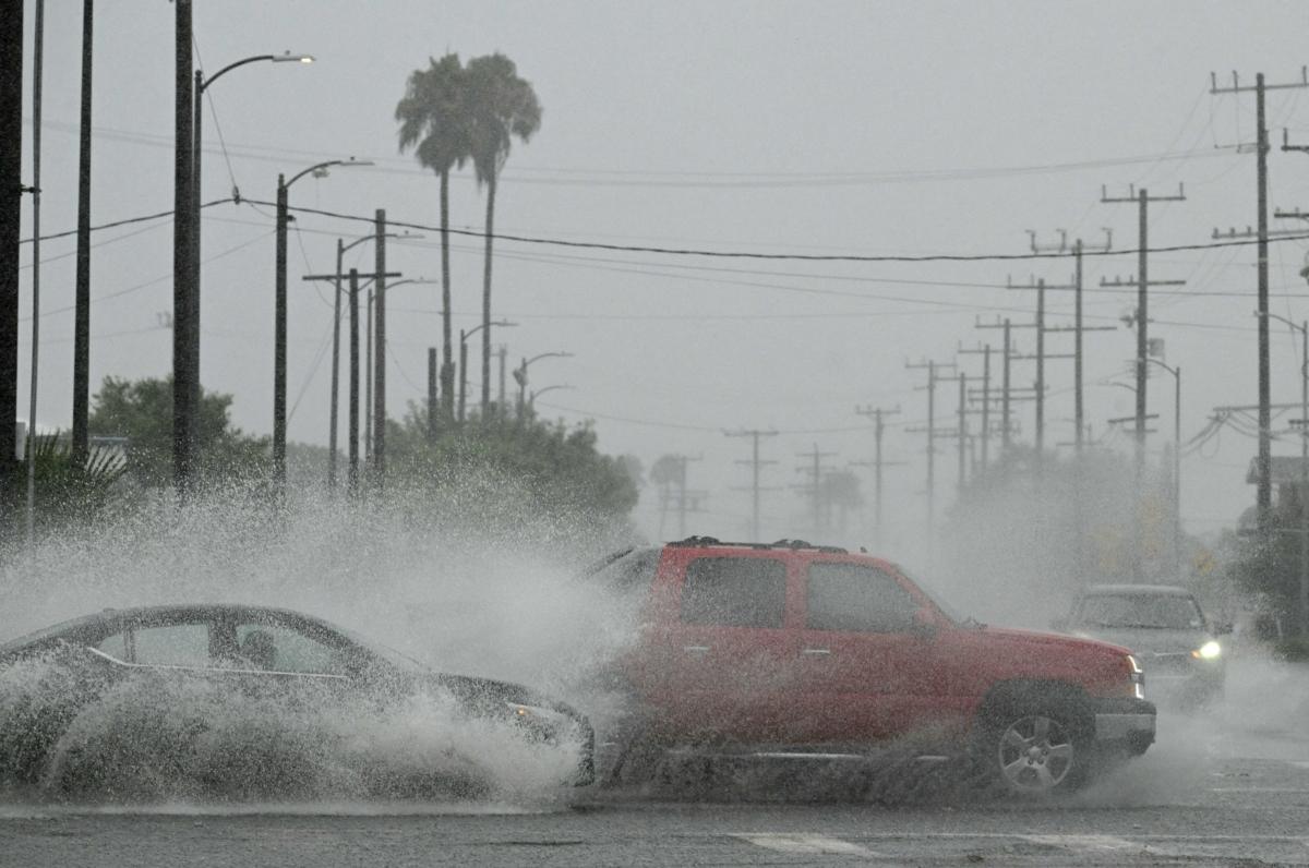 Vehicles splash water during heavy rains from Tropical Storm Hilary, in south Los Angeles, Calif., on Aug. 20, 2023. (Robyn Beck/AFP via Getty Images)