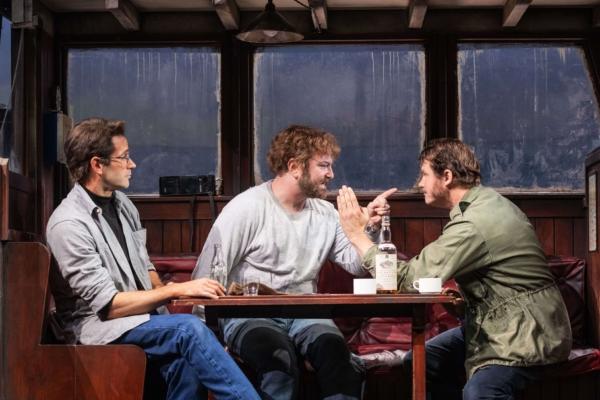 (L–R) Roy Scheider (Colin Donnell) watches as Richard Dreyfuss (Alex Brightman) and Robert Shaw (Ian Shaw) argue, and they do that a lot in “The Shark Is Broken.” (Matthew Murphy)