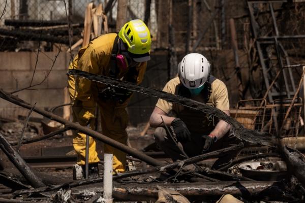 Search and recovery team members check charred buildings and cars in the aftermath of the Maui wildfires in Lahaina, Hawaii on Aug. 18, 2023. (Yuki Iwamura/AFP via Getty Images)
