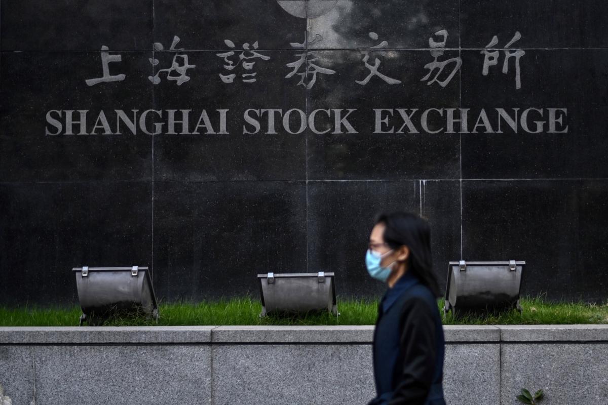 A pedestrian walked past the Shanghai Stock Exchange in Shanghai, on Nov. 4, 2020.s (Hector Retamal/AFP via Getty Images)