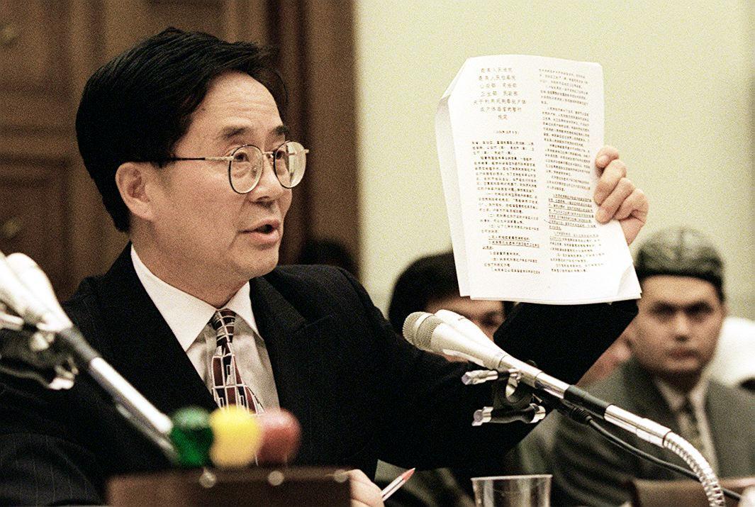 Harry Wu, executive director of the Lagoi Research Foundation and former Chinese prisoner, holds up official Chinese documents describing the harvesting of human organs from Chinese prisoners, during hearings conducted by the House Subcommittee on International Operations and Human Rights, on Capitol Hill, on Oct. 28, 1997.  (William Philpott/AFP via Getty Images)
