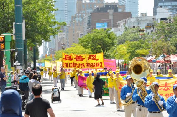Hundreds of Falun Gong adherents held a parade in downtown Toronto on Aug. 19, 2023, to celebrate 417 million Chinese people quitting the Chinese Communist Party and its affiliated organizations. (Evan Ning/The Epoch Times)