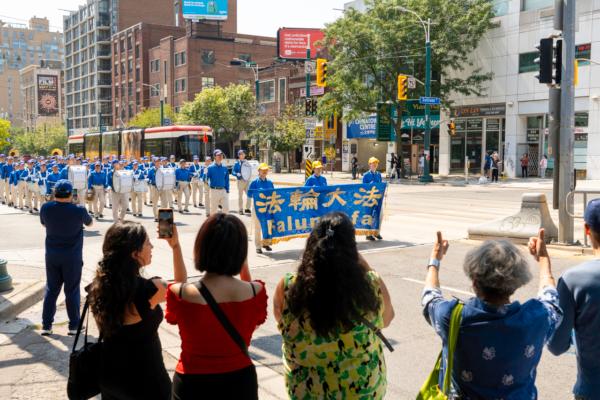 Hundreds of Falun Gong adherents hold a large-scale parade in downtown Toronto on Aug. 19, 2023, to celebrate 417 million Chinese people quitting the Chinese Communist Party and its affiliated organizations. (Evan Ning)