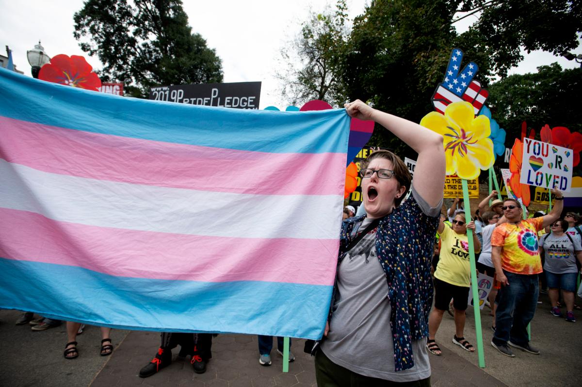 An activist on behalf of transgenderism holds up a flag at an event in Atlanta, Ga., on Oct. 12, 2019. (AP Photo/Robin Rayne)