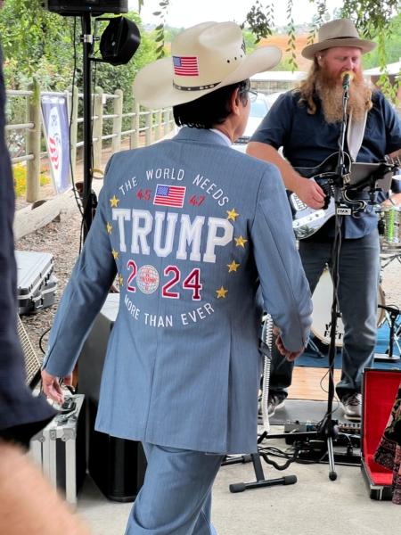 Tien Tran, one of the “front row joes” at Trump rallies, sports a hat, blazer, and tie embroidered with “The World needs Trump more than ever" at a private event held at a ranch in northern Orange County, Calif., on Aug. 19, 2023. (Brad Jones/The Epoch Times)