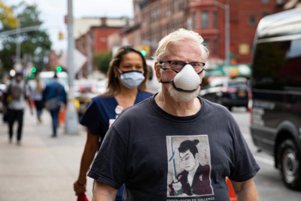 People wearing protective face masks walk on the street in Brooklyn, New York, on October 7, 2020. (Chung I Ho/The Epoch Times)