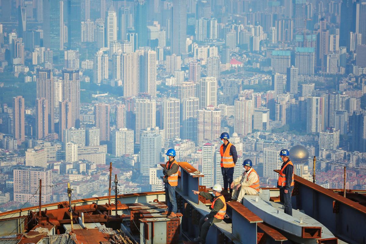 Construction workers gather at the construction site of the Wuhan Greenland Center, a 636-meter-high skyscraper, in Wuhan, Hubei Province, China, on April 24, 2020. (STR/AFP via Getty Images)